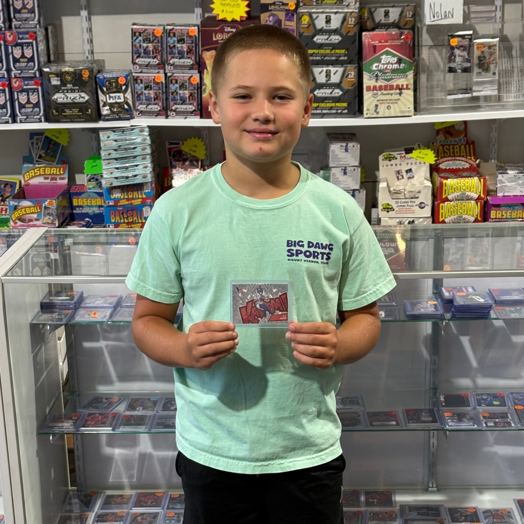 Young collector showing off a card pull at Big Dawg Sports