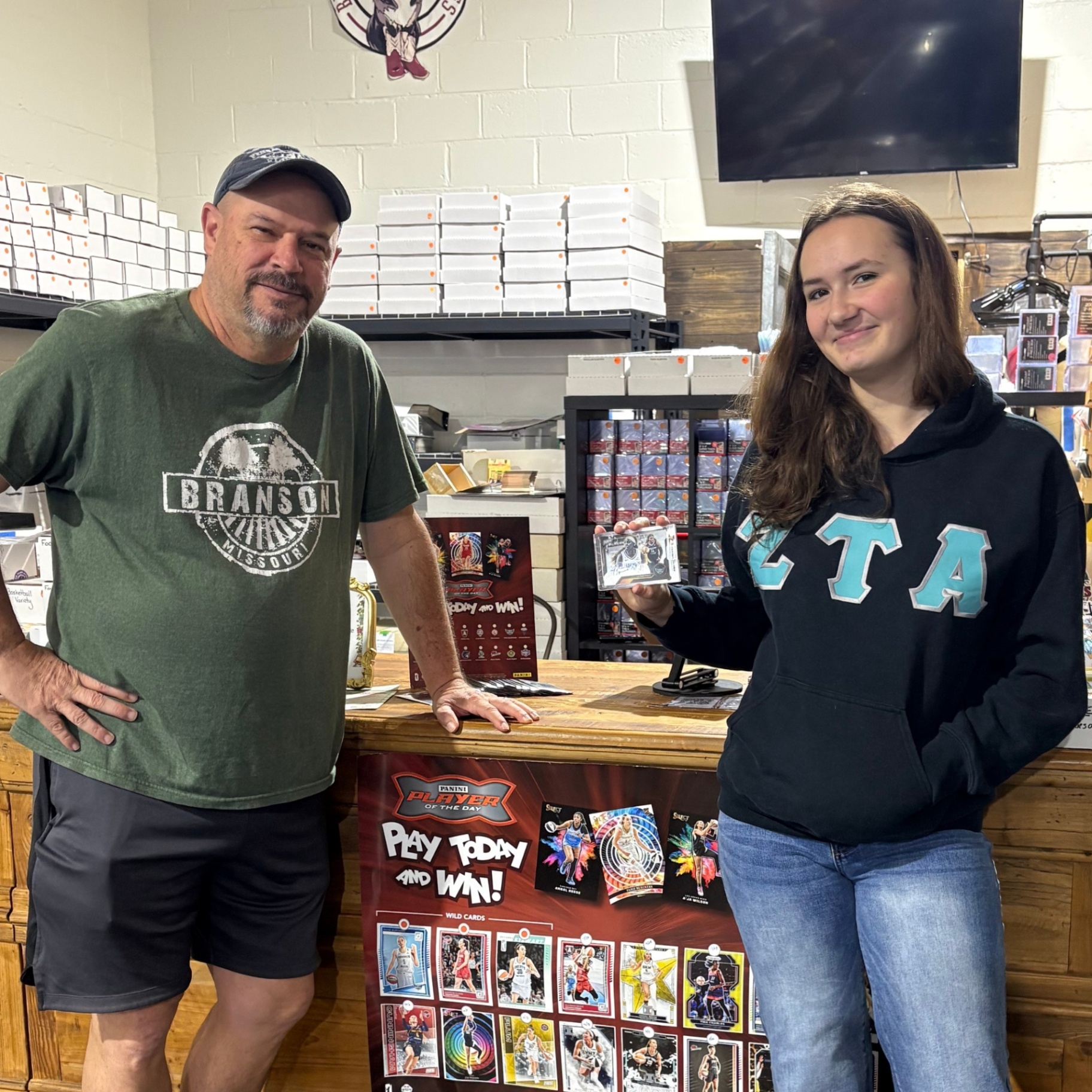 Collectors at the counter with a signed card